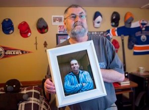 Ernie LeBlanc hold a photo of his son Jason LeBlanc at their home in Sydney Mines, N.s. on Monday, March 14, 2016. Jason died in custody at the Cape Breton Correctional Centre in January. THE CANADIAN PRESS/Andrew Vaughan