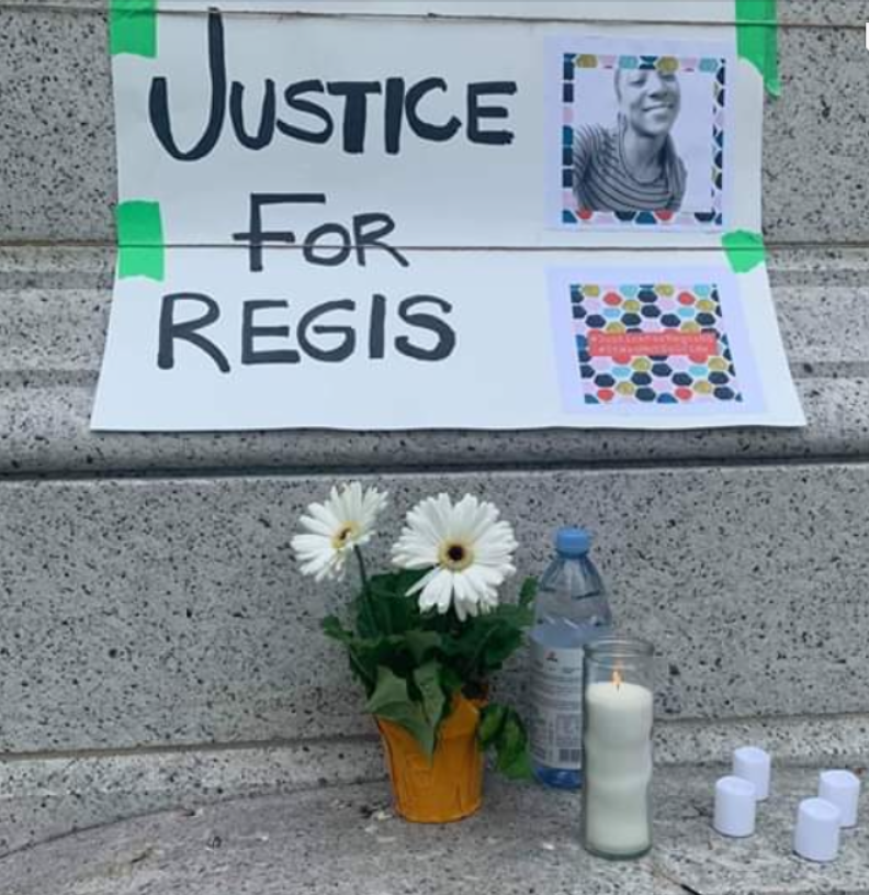 与鲜花和蜡烛一起与“regis正义”的标志