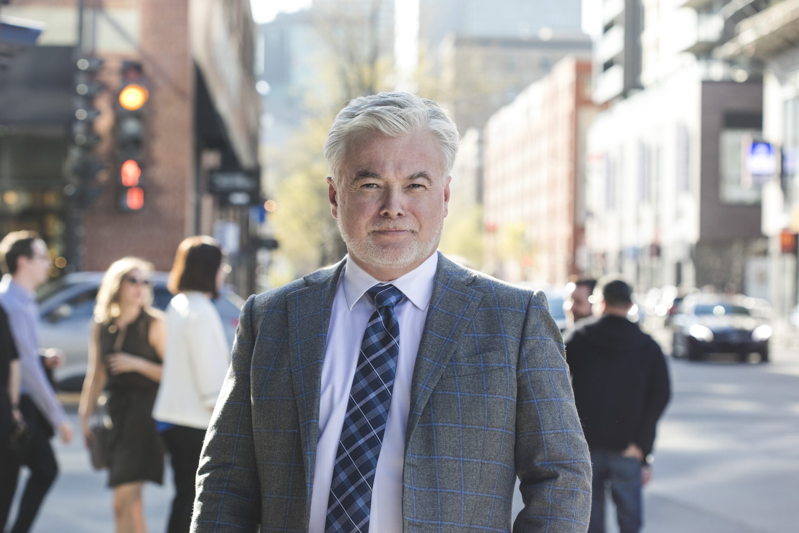 Middle-aged man in a suit on the street.