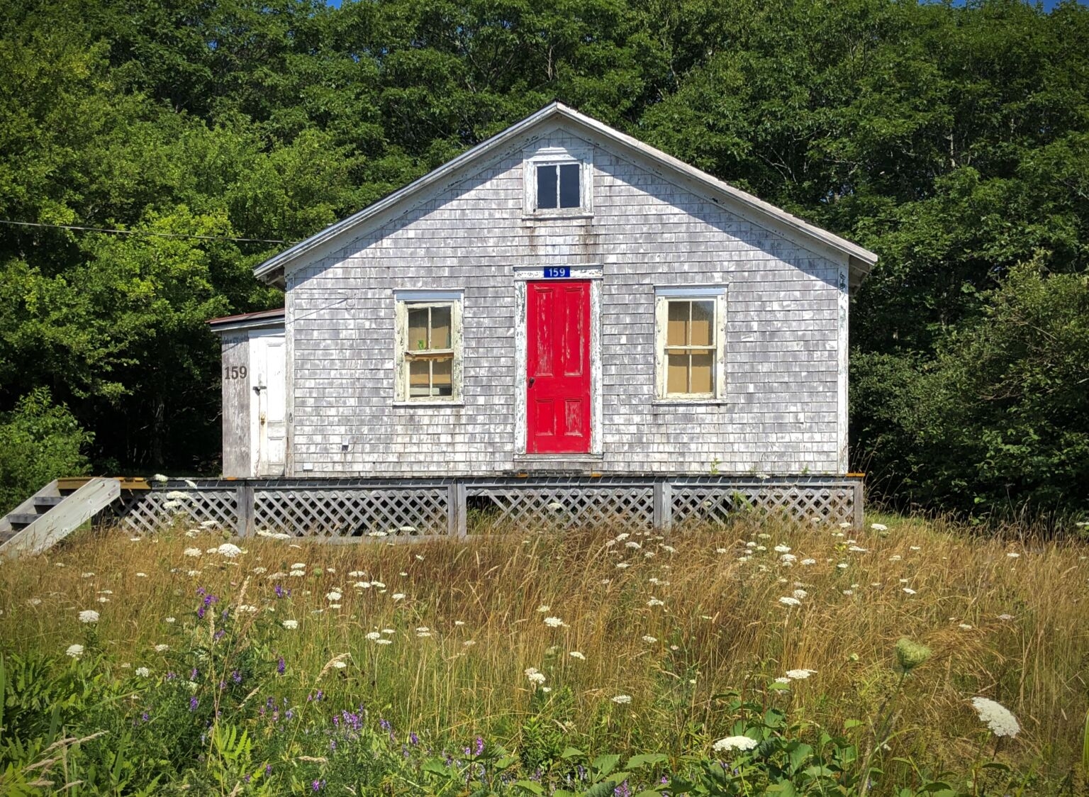 Small cottage with bright red door.