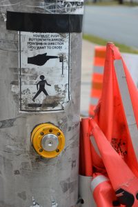 Crosswalk with pedestrian button and flags