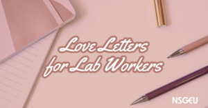 一个淡粉色的图形，中间是写有“给实验室工作人员的情书”的纸和笔。