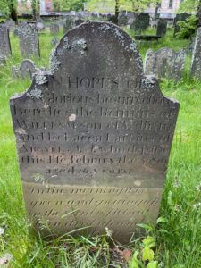 墓石墓顶有拱形的墓碑前两行写着“希望光荣复活”。