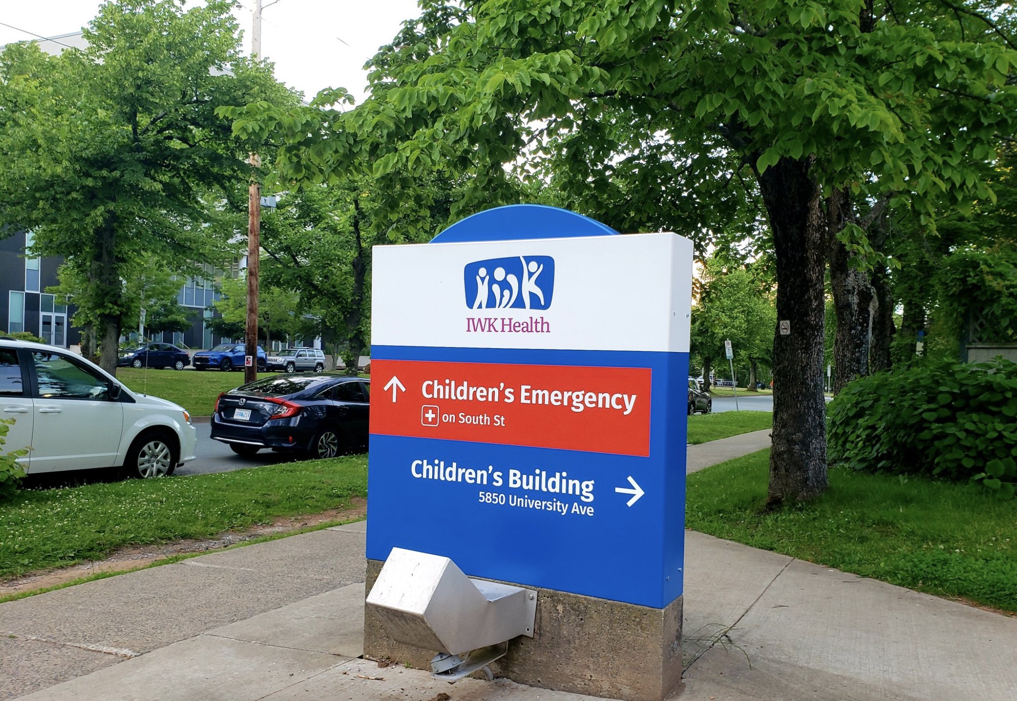 A sign outside the IWK Health Centre shows the direction of the children's emergency department and the children's building.