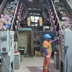 一名男子在倾斜的传送带上分类垃圾