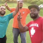 Three Black men playing golf and wearing bright Tshirts