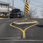 A car drives around a trafic calming island