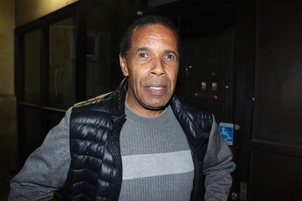 A photo of Raymond Sheppard, who is wearing a grey sweater under a black puffy vest.