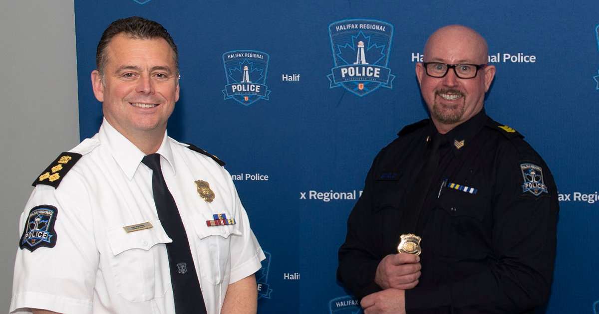 Halifax Police Chief Can Kinsella and Insp. Derrick Boyd at a 2020 promotion ceremony. Kinsella is wearing a white shirt with black tie and his police badges. Boyd is in a dark uniform and his holding a badge.