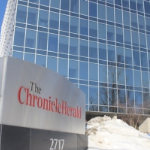 Thetall blue glass expanse of the Chronicle Herald Building on a sunny winter day