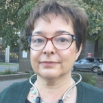 a closeup of Dr. Gabrielle Horne with a stethoscope around her neck, standing outside on an overcast day