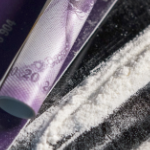 a line of cocaine beside a rolled up bill