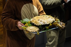 Protestor dressed in a moose costume holds a tray with a 