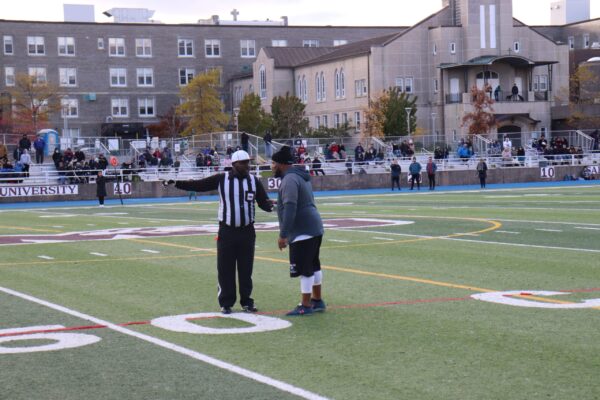 文斯·威廉姆斯向奥本大学教练迪昂·托马斯·霍奇斯解释国旗召唤