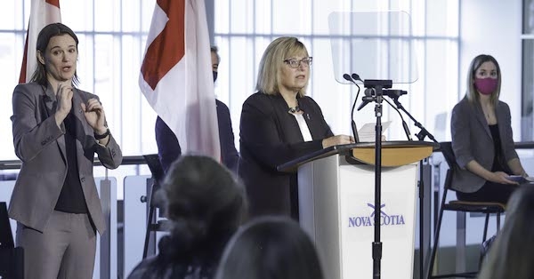 a woman standing at a podium