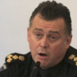 Chief Dan Kinsella speaks into a microphone
