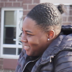 凯拉·博登（Kayla Borden），一个黑人妇女，在与某人交谈时微笑