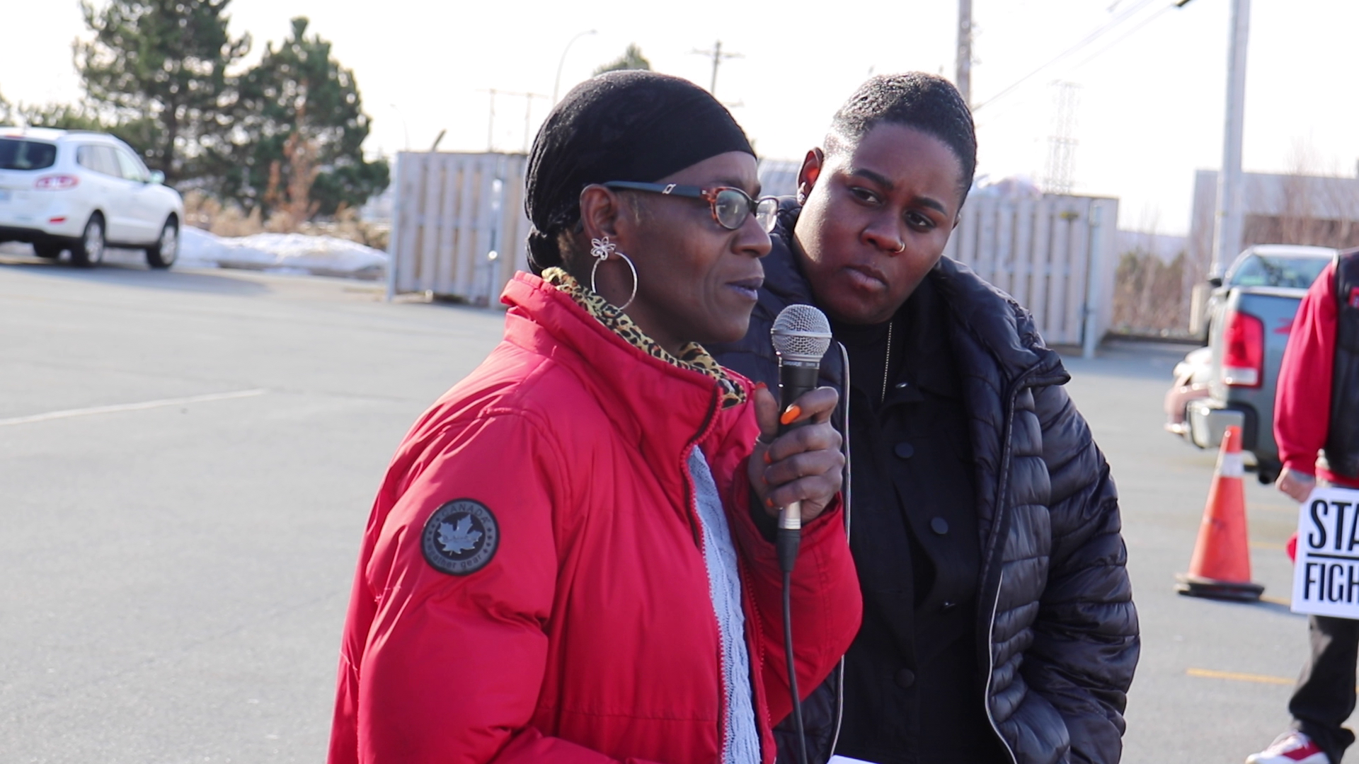 Kayla Borden looks on as her mother speaks at a noon time rally held in support of Borden outside of the appeal hearing. Photo: Matthew Byard