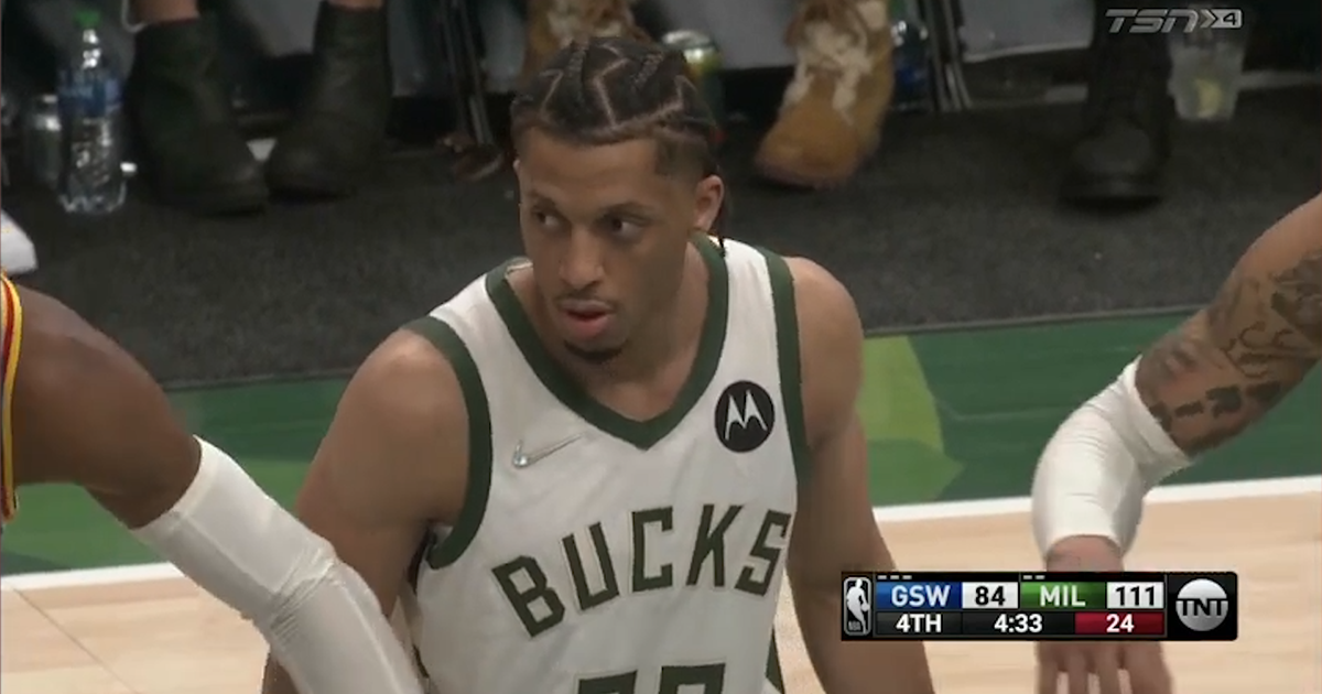 林德尔·威金顿，身穿白色“雄鹿”主场球衣，看着他的对手罚球