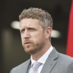 伊恩·兰金穿着灰色西装，打着领带