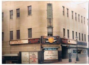 Building at the corner of Sackville and Barrington Streets with signs advertising bands