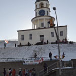 the Citadel Clock with a few protesters around it on a sunny day in February