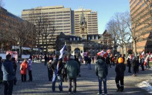 A group of Canadian flag-waving people gather at Parade Square in Halifax.