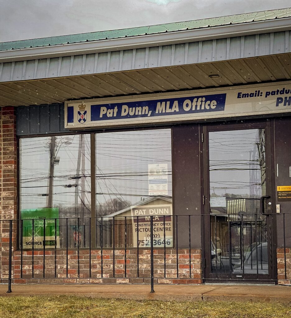 This photo shows the front of the New Glasgow MLA constituency office of Pat Dunn, Minister of African Nova Scotian Affairs, and prominently displayed in the front window is a sign from the 