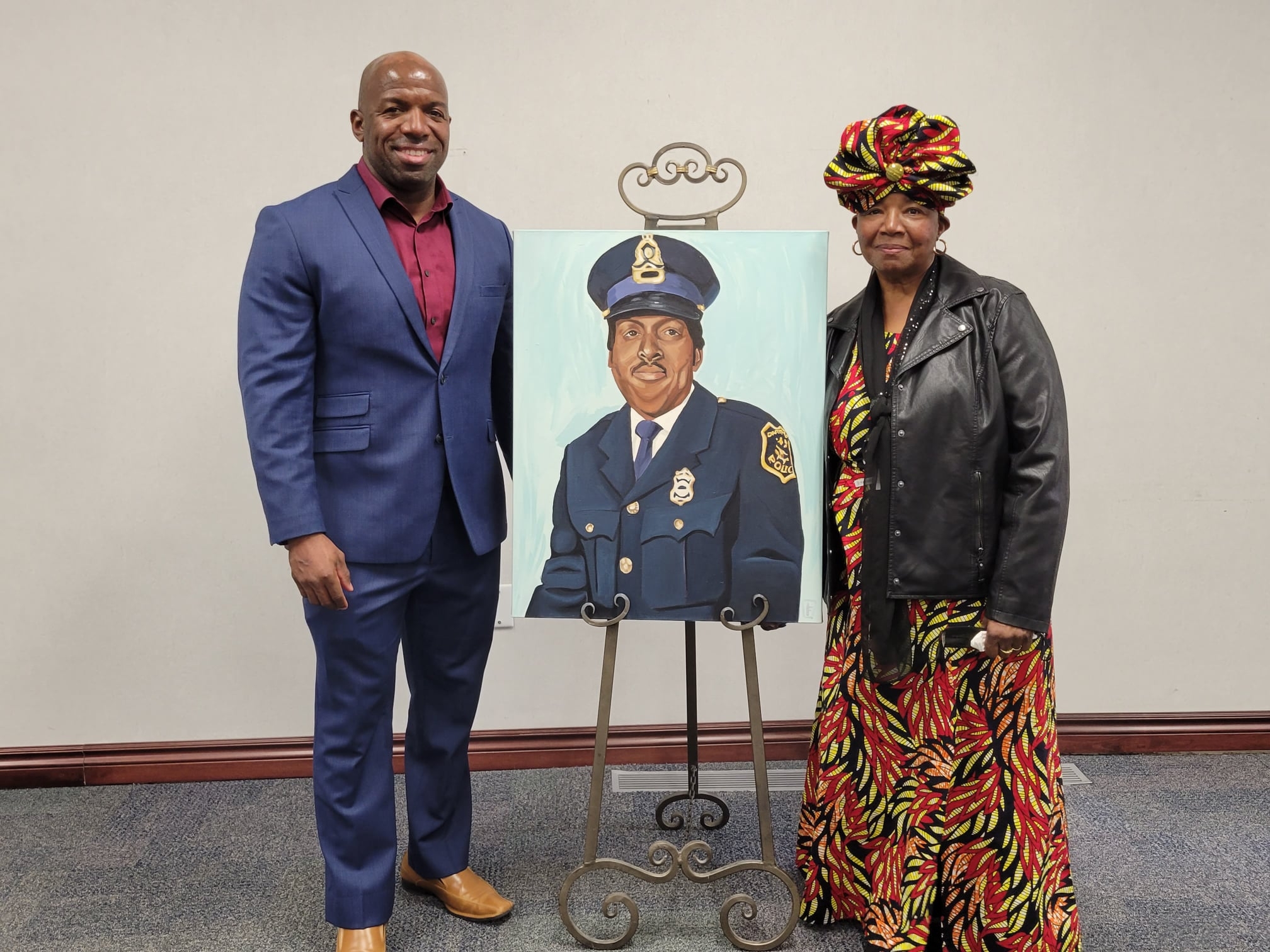 Portrait unvieled of the late Sinclair Williams, the first Black police officer on the Dartmouth Police Department. His son and wife Evan and Dolly Williams pose with the portrait. Photo: Halifax Regional Police.