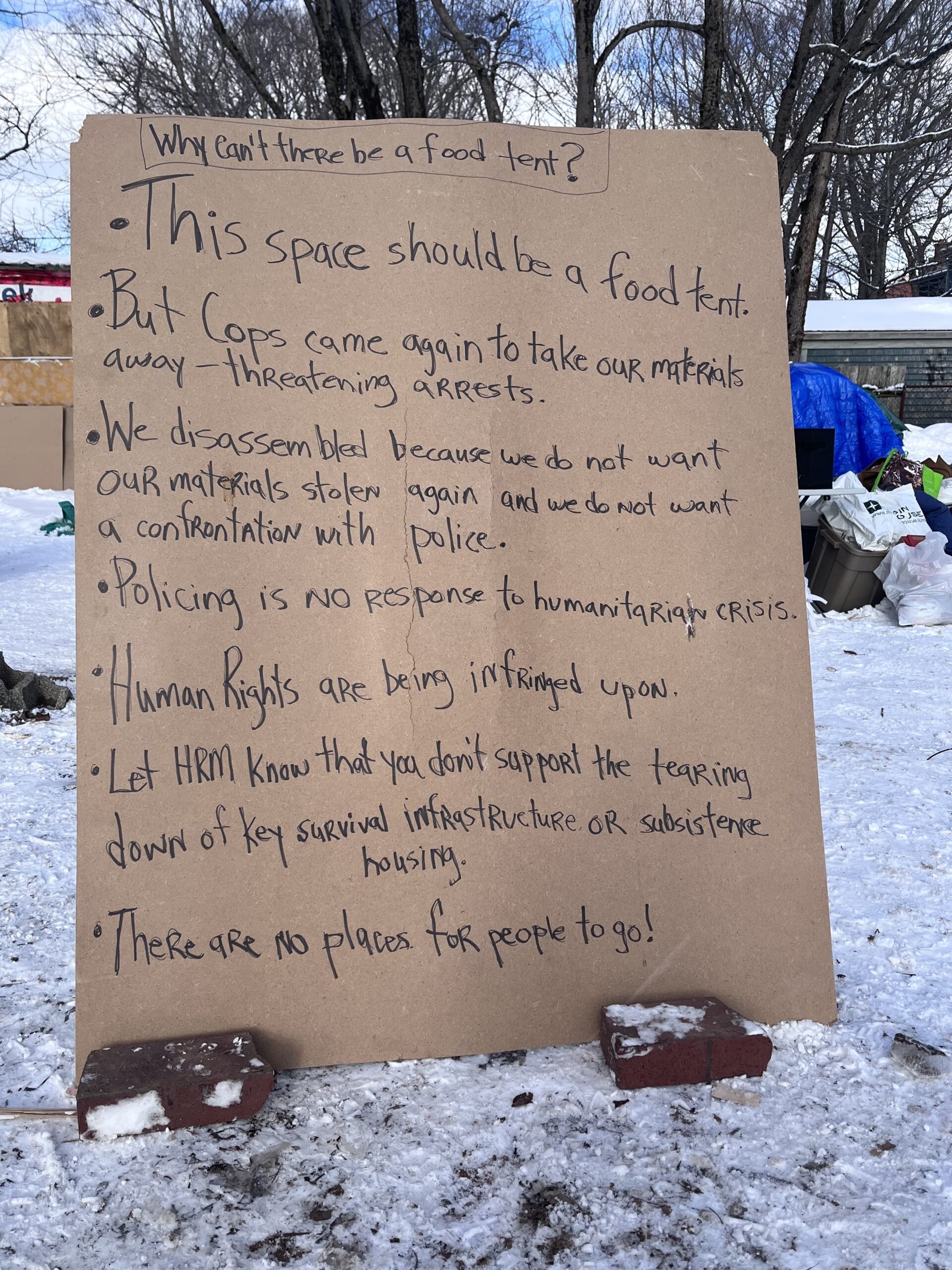 人民公园外的一个纸板牌子上写着，这个牌子所占的地方应该是一个食物帐篷，但是警察不允许