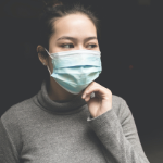 一个戴着蓝色一次性口罩的亚洲女人