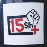 杆子上挂着一个拳头的海报，上面写着“每小时加15美元”。