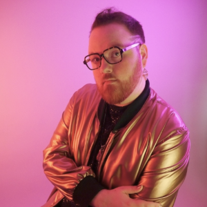 KR Byggdin wearing a metallic gold jacket