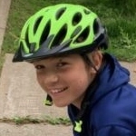 A young boy wearing a skating boarding helmet