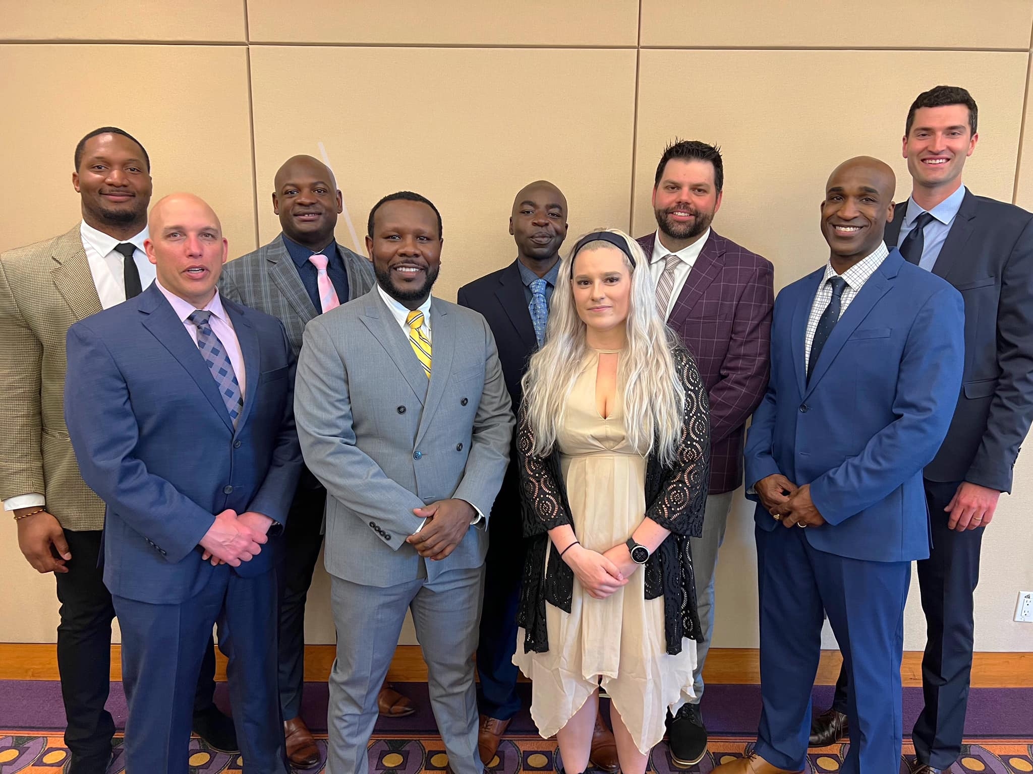 Eight men and a woman pose as part of the inaugural CFL Officiating Academy