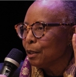 A photo of Evelyn White at a microphone