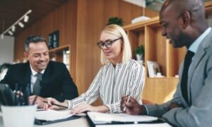 Three people sit at a table