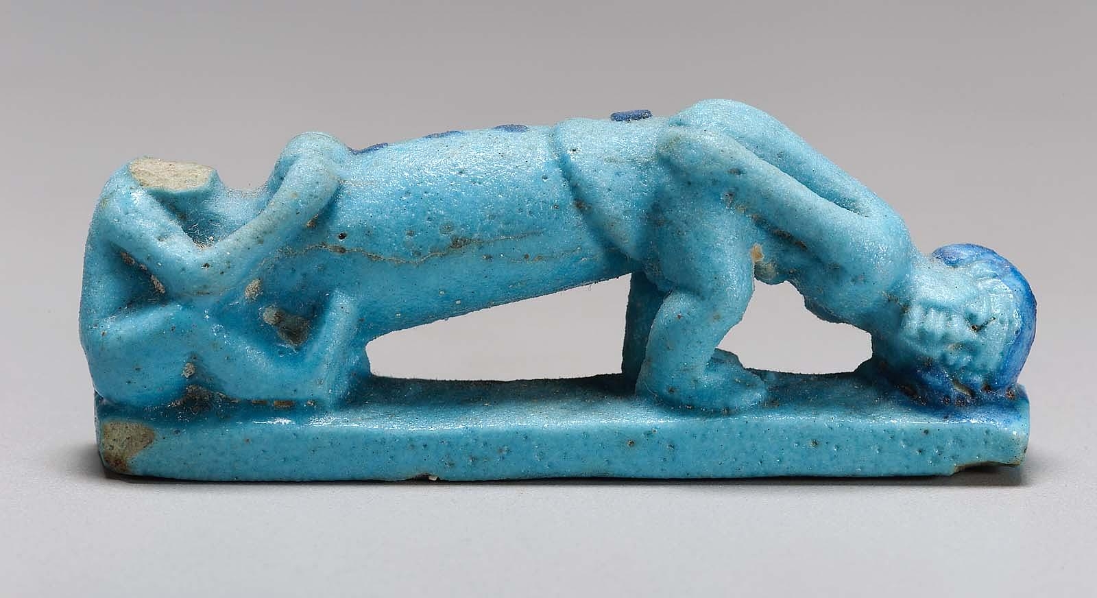 蓝色的图形，一个男人斜倚着，一个巨大的阴茎(比他的身体大得多)压在他前面弯腰的女人的后面。