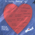 A handmade sign with a bright red heart with names written on it