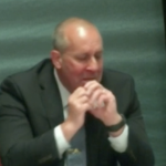 A white man in a dark suit speaking at the Mass Casualty Commission