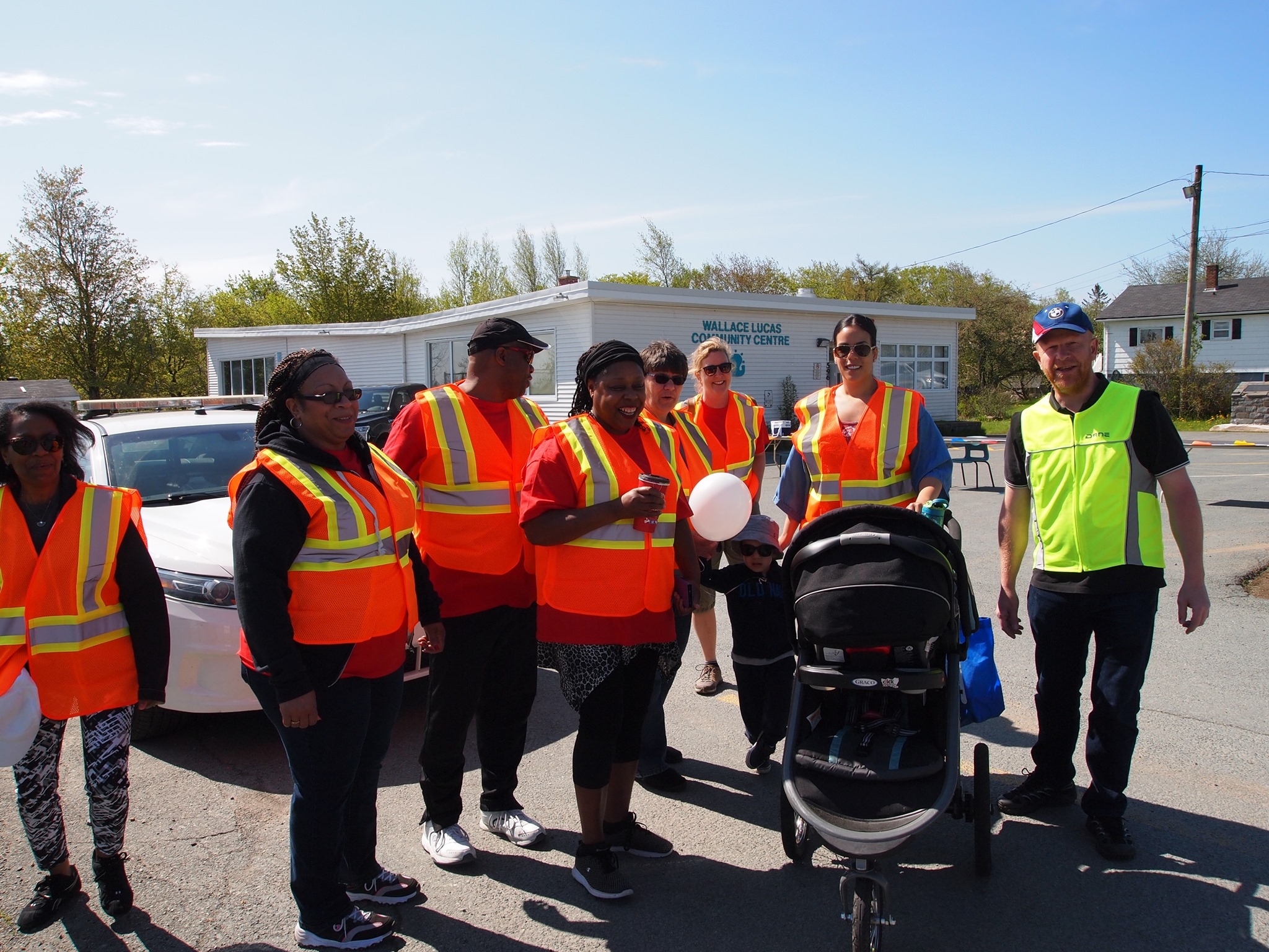Community members in orange refective vests