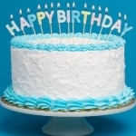 A birthday cake with white icing and blue icing trim. Candles on top of the cake spell out Happy Birthday