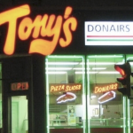The outside of a donair shop at night