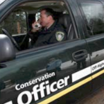 A conservation officer in his truck