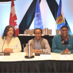 Three Black people at a panel table