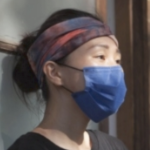A young Asian woman wearing a blue mask