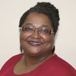 a smiling Black woman wearing a bright red top