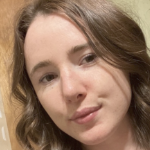 A young white girl with brown hair in a selfie