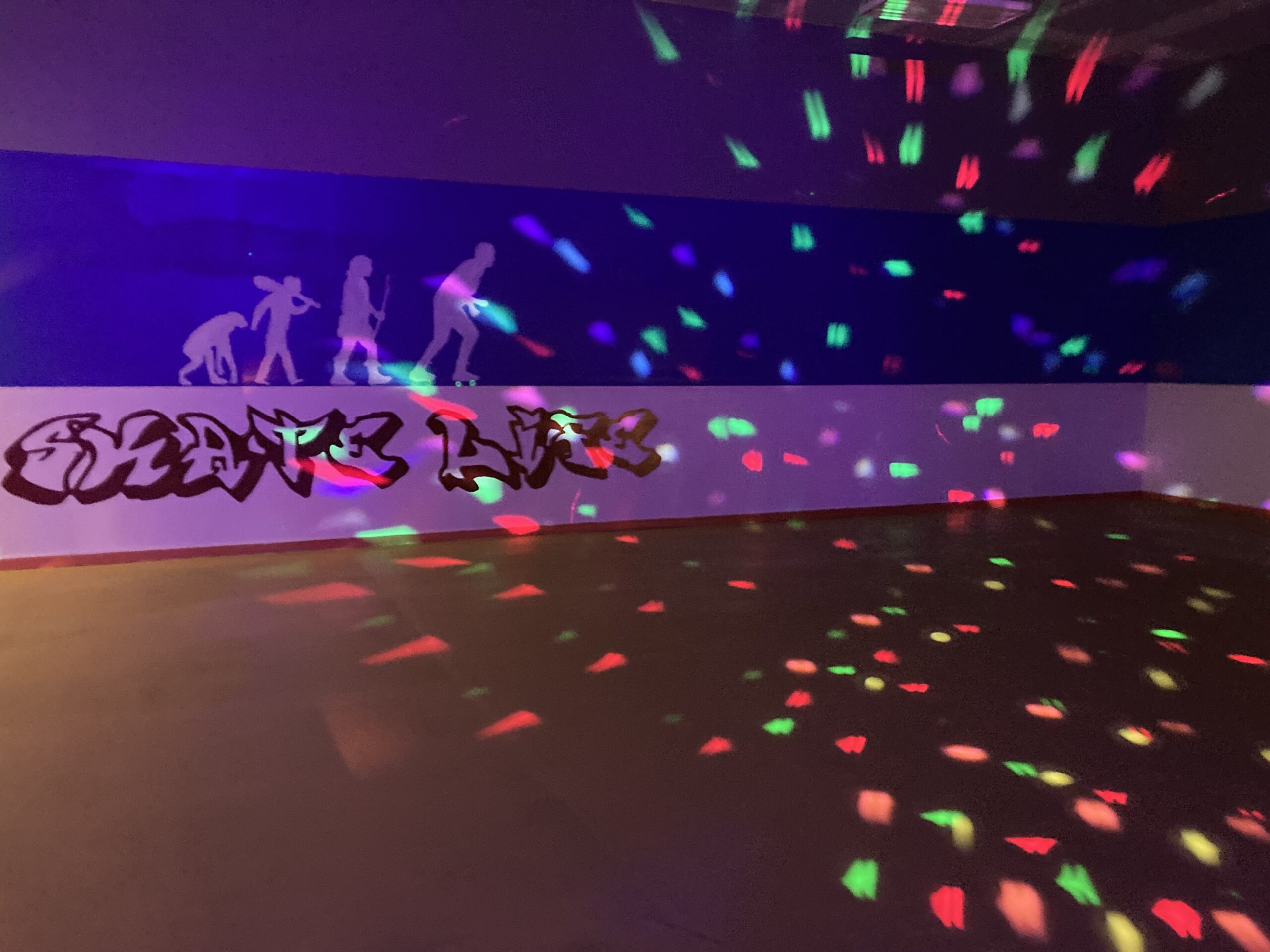 滚筒溜冰场，带有迪斯科球的明亮灯光