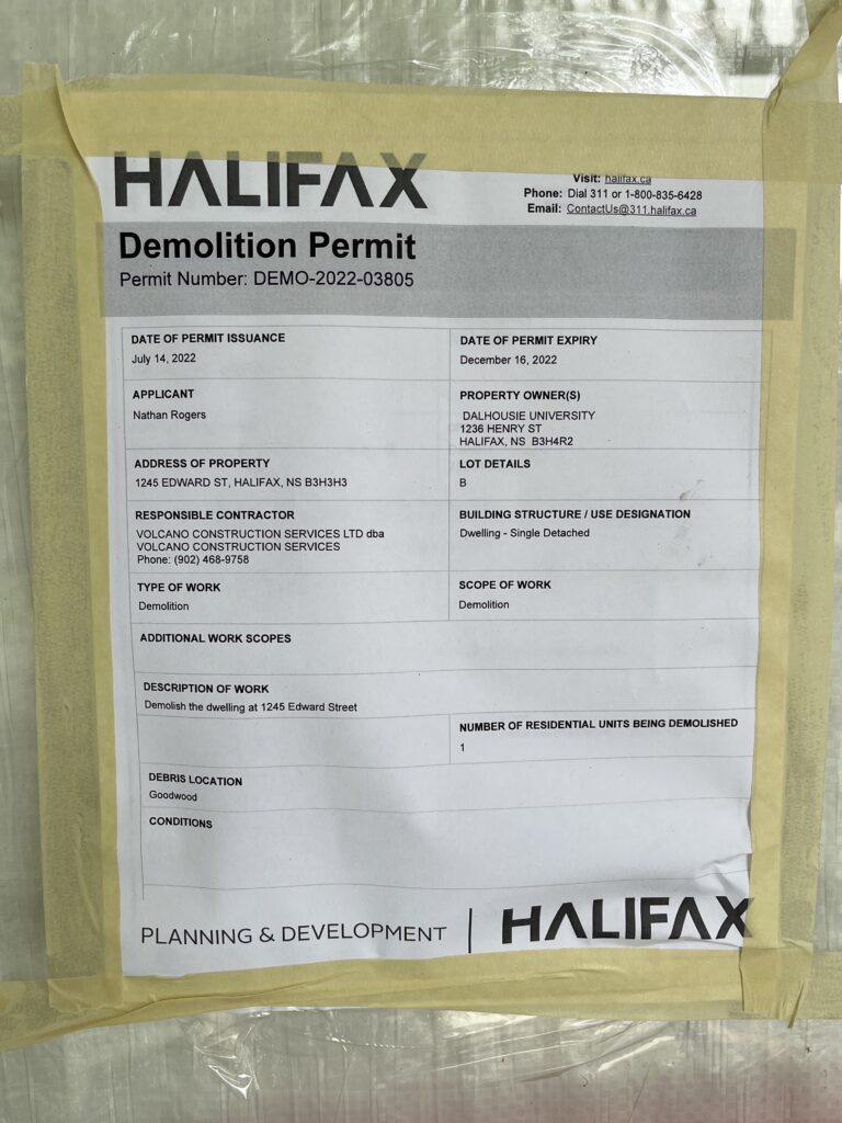 A HALIFAX-branded sheet of paper masking-taped to a door is shown, with 